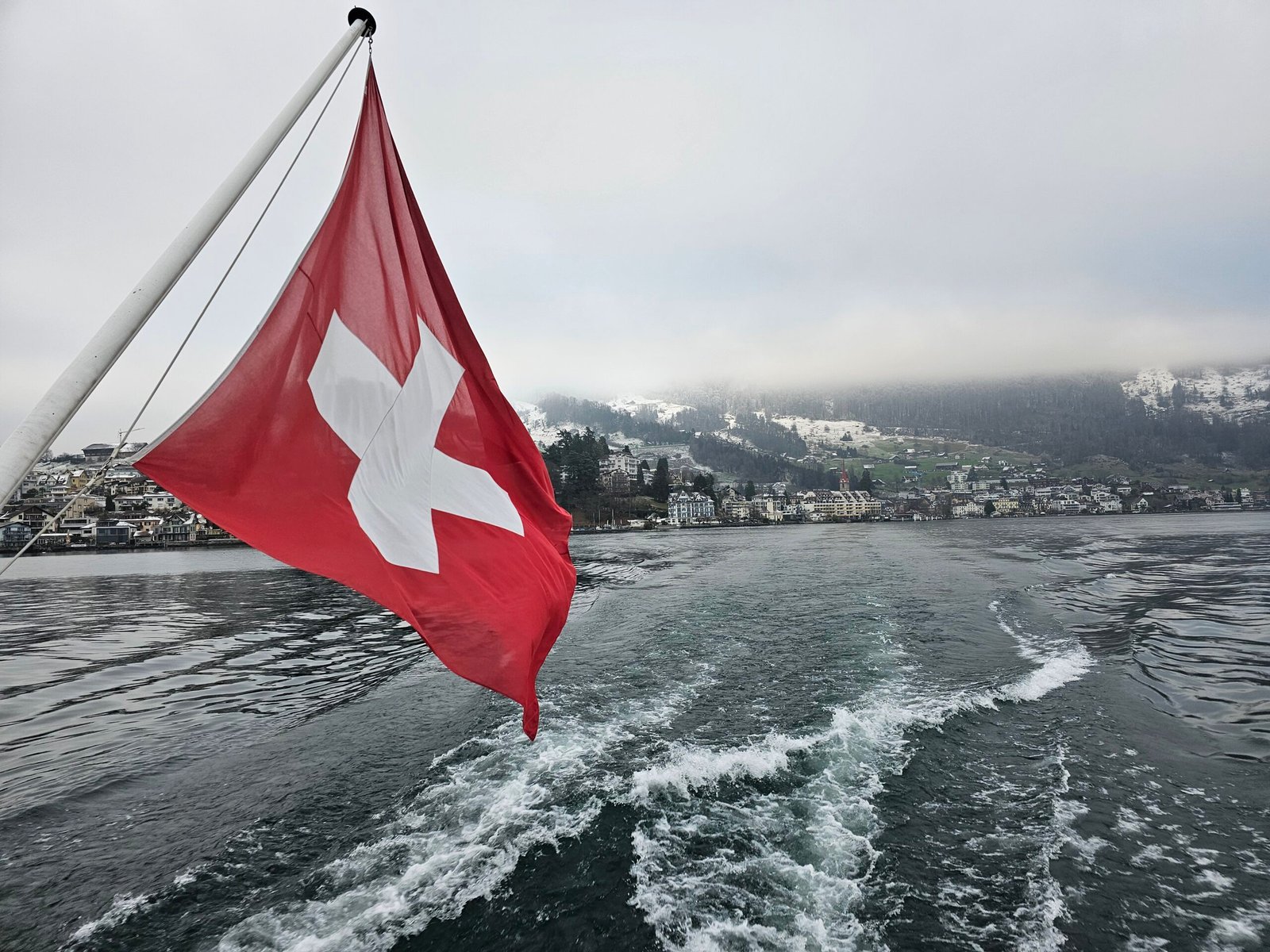 Lake in Luzern, Switzerland, with a Swiss flag, representing Cyberfulness and mindful digital well-being.