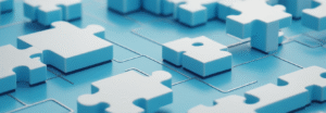 Blue and white puzzle pieces connecting together representing SaaS software integration and modular cloud solutions